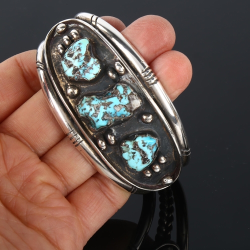 1289 - A heavy Native American Navajo turquoise cuff bracelet, unmarked silver settings, setting height 35.... 