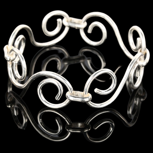 1313 - A handmade sterling silver abstract spiral bangle, by Claude Wilkes, hallmarks London 2016, setting ... 