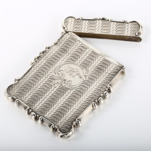 1356 - An Antique unmarked silver card case, allover engine turned decoration with engraved village and lak... 