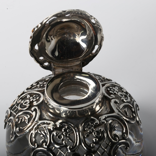 1359 - An Edwardian silver-mounted glass desk inkwell, relief embossed and pierced foliate decoration, by W... 