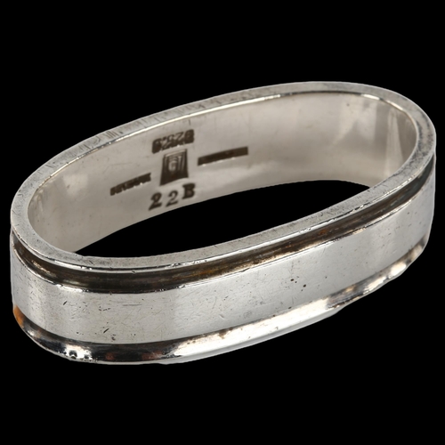 1363 - GEORG JENSEN - a Danish modernist sterling silver napkin ring, designed by Harald Nielsen, model no.... 