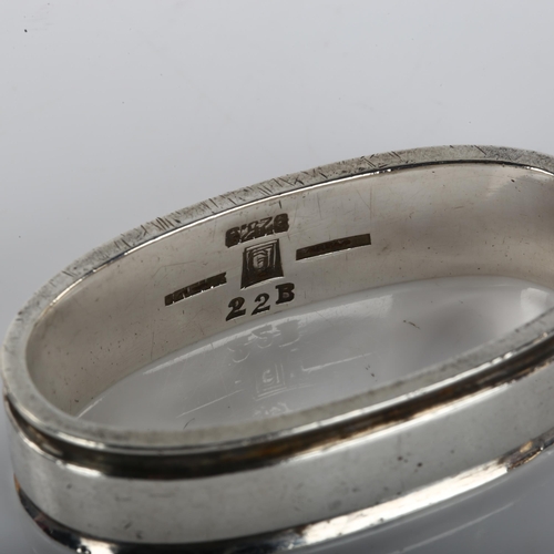 1363 - GEORG JENSEN - a Danish modernist sterling silver napkin ring, designed by Harald Nielsen, model no.... 