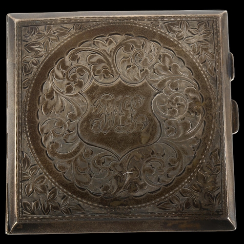 1371 - A George V curved silver cigarette case, square form with allover engraved foliate decoration and gi... 