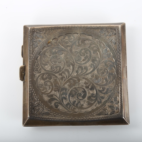 1371 - A George V curved silver cigarette case, square form with allover engraved foliate decoration and gi... 