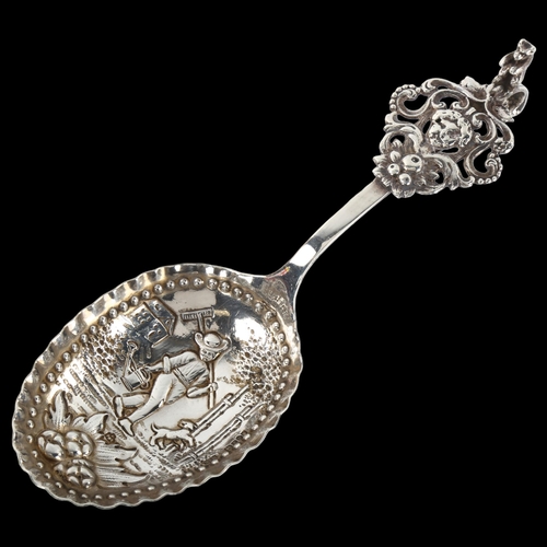 1376 - A large Dutch silver spoon, circa 1900, with relief embossed farmer bowl and standing bear handle, l... 