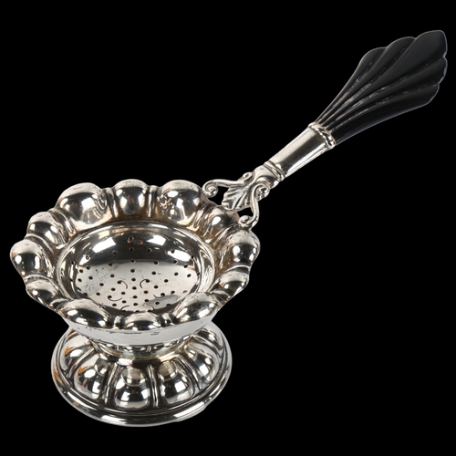 1379 - CARL M COHR - a Danish Art Deco silver and Bakelite tea strainer and stand, strainer length 15cm, 2.... 