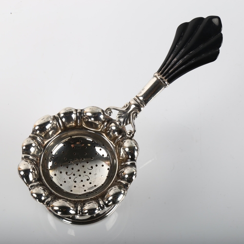 1379 - CARL M COHR - a Danish Art Deco silver and Bakelite tea strainer and stand, strainer length 15cm, 2.... 