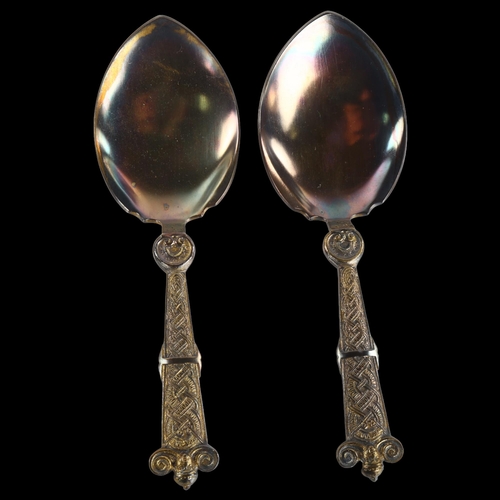 1387 - A pair of Danish silver Viking Revival serving spoons, dated 1919, length 15cm, 3.3oz total