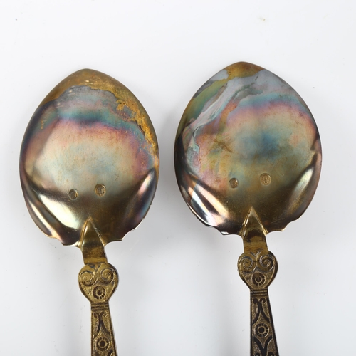 1387 - A pair of Danish silver Viking Revival serving spoons, dated 1919, length 15cm, 3.3oz total