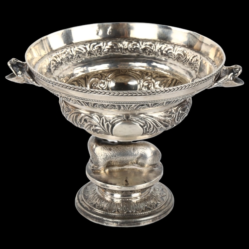 1389 - An Antique Continental silver pedestal bowl, with ewe support, grotesque mask handles and relief emb... 