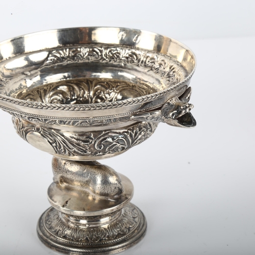 1389 - An Antique Continental silver pedestal bowl, with ewe support, grotesque mask handles and relief emb... 