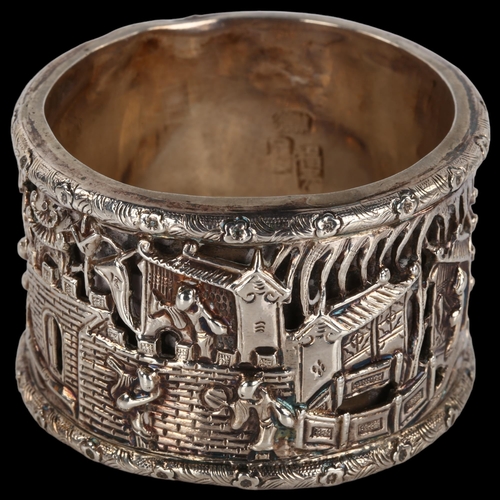 1397 - A Chinese export double-skinned silver napkin ring, high relief temple scenes with character marks, ... 