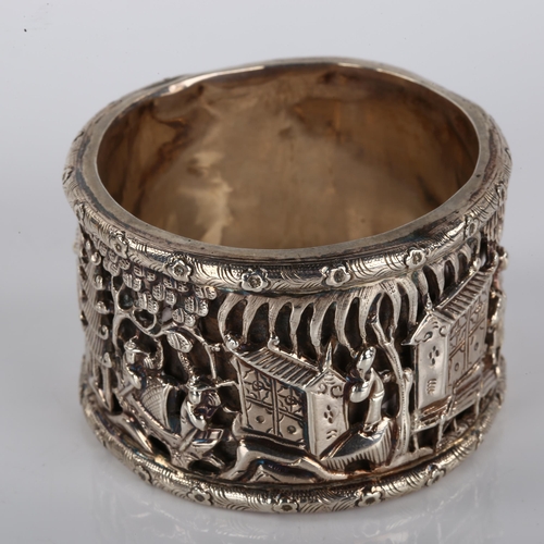 1397 - A Chinese export double-skinned silver napkin ring, high relief temple scenes with character marks, ... 