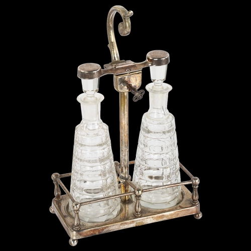 1409 - A German Art Nouveau silver plated perfume tantalus, with locking mechanism and cut-glass bottles, c... 