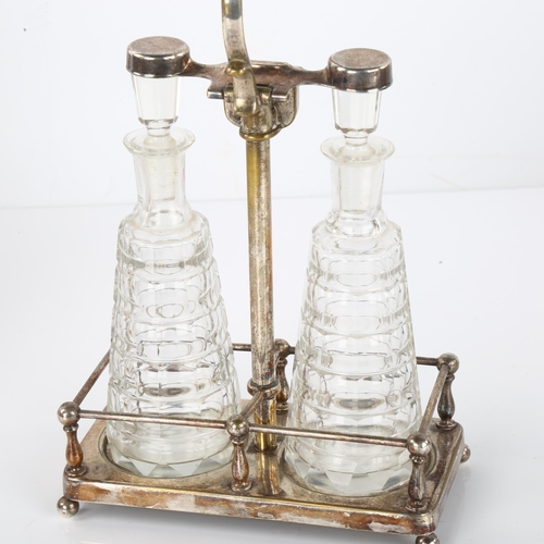 1409 - A German Art Nouveau silver plated perfume tantalus, with locking mechanism and cut-glass bottles, c... 