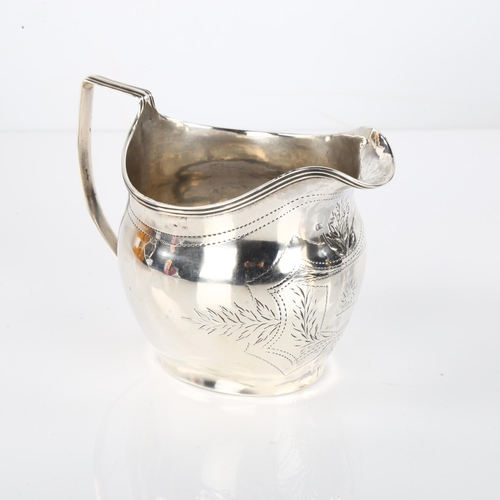 1413 - A George III silver helmet cream jug, with bright-cut engraved decoration and reeded rim, probably b... 