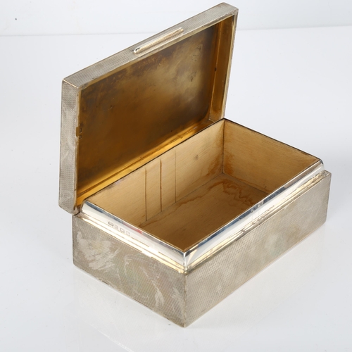 1421 - HARRODS - a heavy George V Art Deco silver cigarette box, allover engine turned decoration with gilt... 