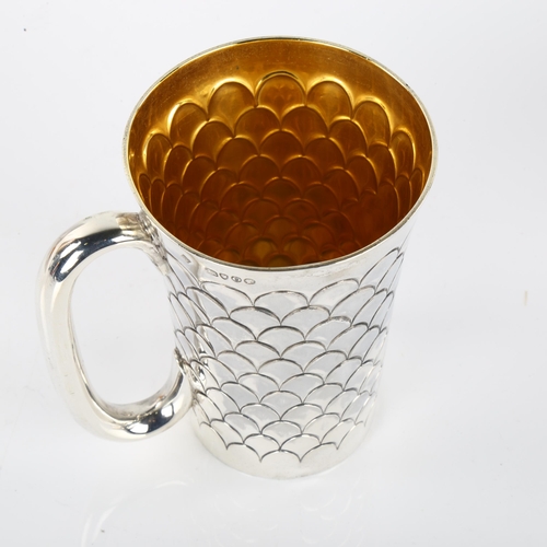 1423 - A Victorian silver mug, tapered cylindrical form with scale decoration and gilt interior, by Martin,... 