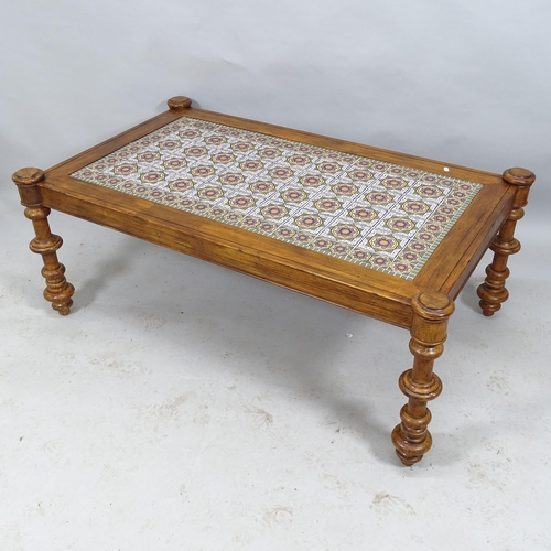 2103 - A moorish design rectangular tile-top table, with stained pine frame raised on turned walnut legs. 1... 