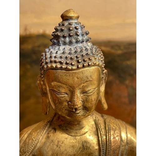 211 - A Chinese gilt-bronze seated Buddha, height 15cm