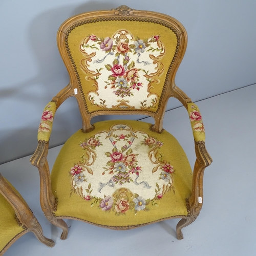 2513 - A pair of French oak and needlepoint upholstered open armchairs.