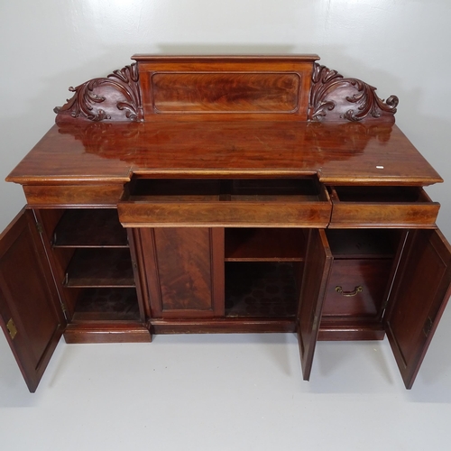 2524 - A Victorian mahogany inverted break front sideboard, with raised carved back and panelled cupboards ... 