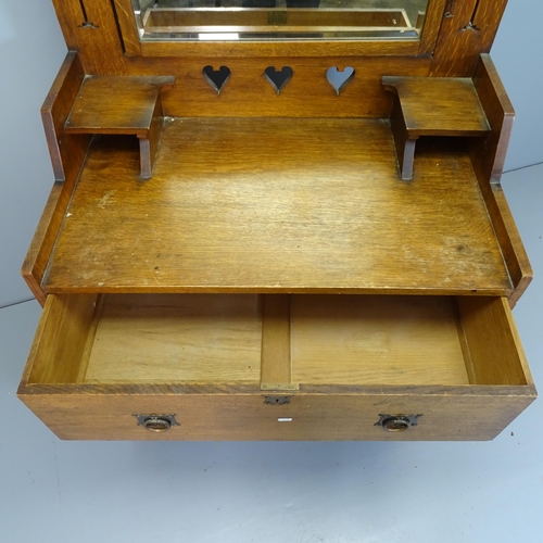 2534 - An Arts and Crafts oak dressing chest with raised mirror mirror back, two long drawers and pierced d... 