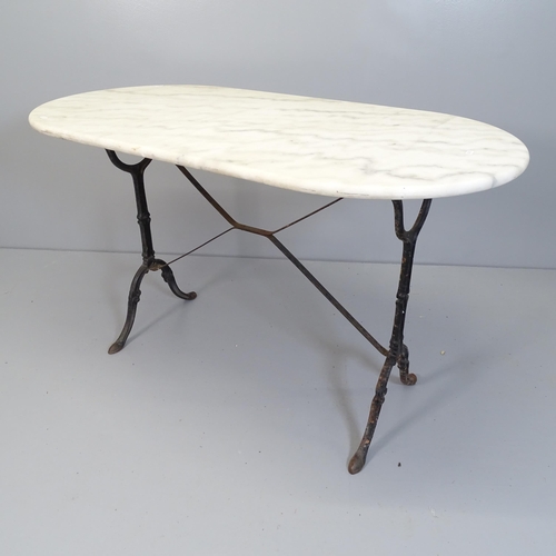 2535 - An oval marble topped garden table on cast iron frame. 120x72x60cm