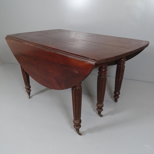 2543 - A Georgian mahoegany draw-leaf drop-end dining table, with three spare leaves, raised on fluted legs... 