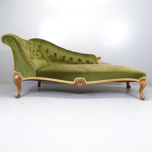 2554 - A Victorian walnut and upholstered chaise longue, with carved decoration and raised on cabriole legs... 