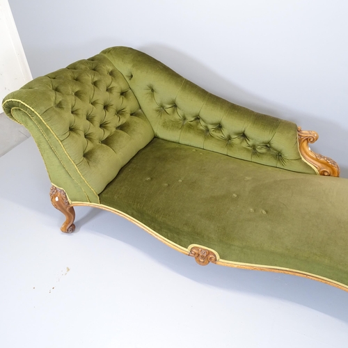 2554 - A Victorian walnut and upholstered chaise longue, with carved decoration and raised on cabriole legs... 