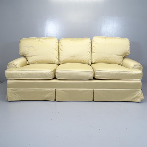 2533 - A contemporary three-seater Chesterfield style sofa, upholstered in champagne coloured dupion silk, ... 