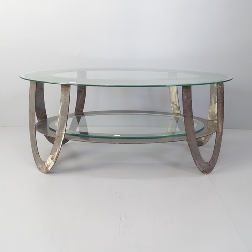 2046 - A contemporary oval two tier glass top coffee table with brushed steel frame. 99x43x61cm