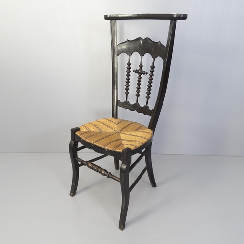 2068 - A French Prie Dieu prayer chair with ebonised frame and reed seat.