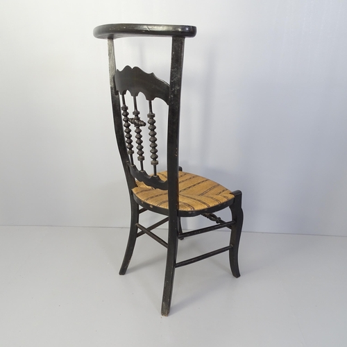 2068 - A French Prie Dieu prayer chair with ebonised frame and reed seat.