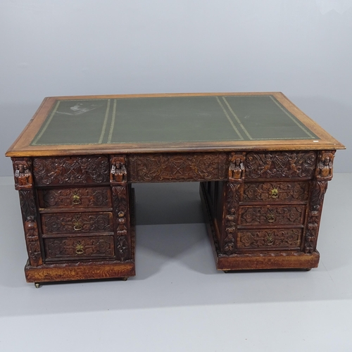 2071 - A Victorian carved oak partner's twin pedestal writing desk, woith tooled and embossed green leather... 