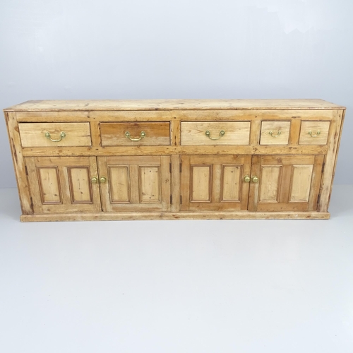 2073 - An antique pine sideboard with five frieze drawers and cupboards under. 215x79x46cm