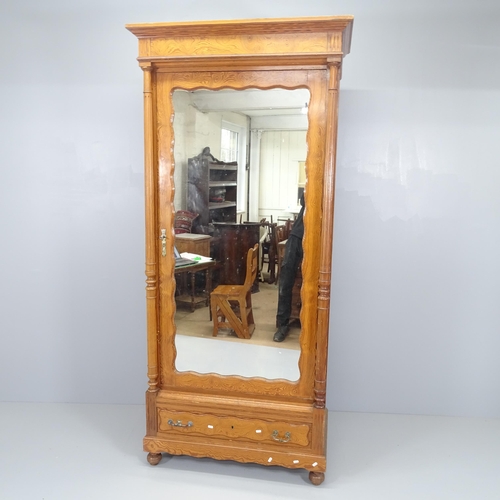 2076 - A French pitch pine armoire with single mirrored door, shelf fitted interior and single drawer under... 