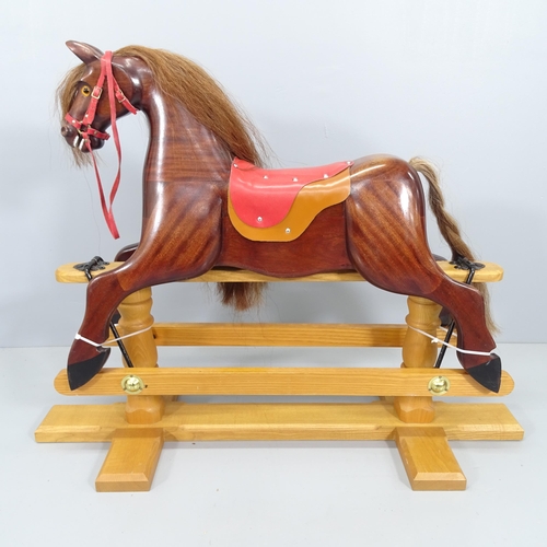 2099 - A modern mahogany rocking horse on pine stand, signed John H. Turner, 1999. Overall 108cmx84x41cm