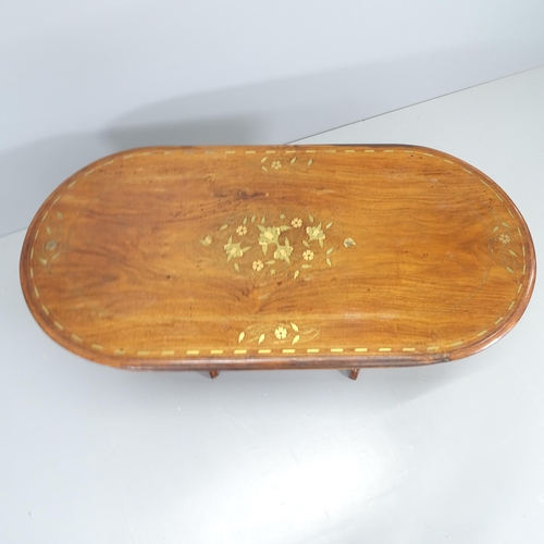 2102 - An Anglo-Indian mahogany and brass-inlaid oval coffee table. 123x49x60cm