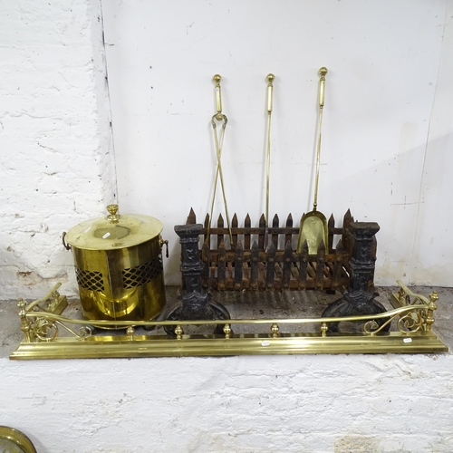 2591 - A cast iron ducks nest fire grate, W 140cm, two fire dogs, a brass companion set, fire surround and ... 