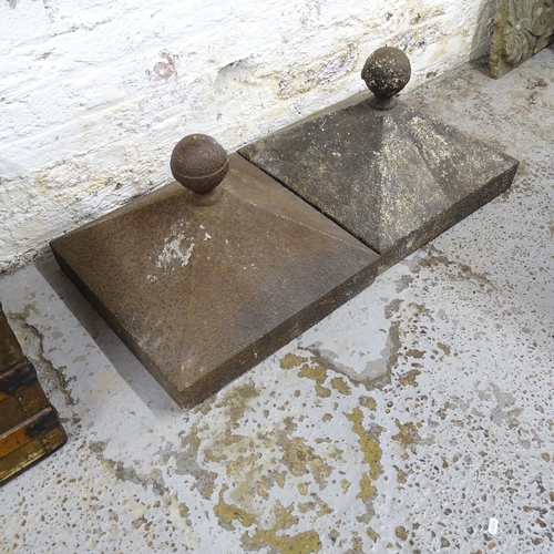 2599 - A pair of square-based cast iron gate-post caps. 49x38cm.