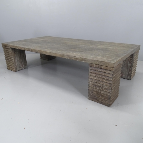 2168 - A contemporary French design cerused oak coffee table on stepped block legs. 150x36x80cm