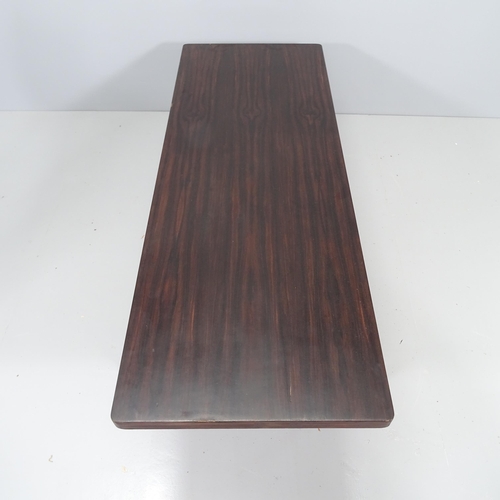 2169 - A mid-century coffee table, the stained walnut veneer top on steel base. 140x39x51cm