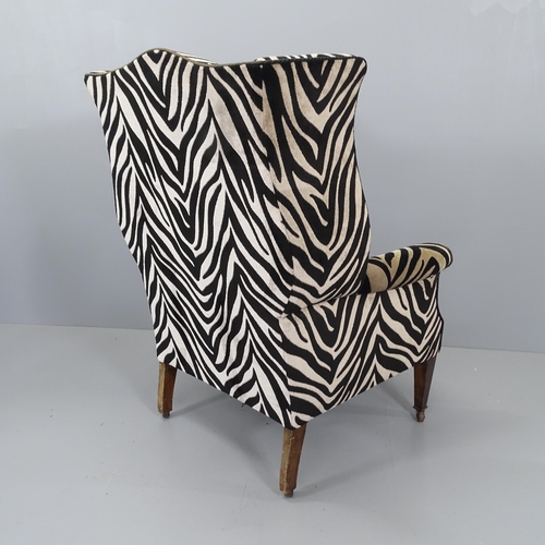 2177 - A Victorian wingback armchair with Zebra style upholstery.