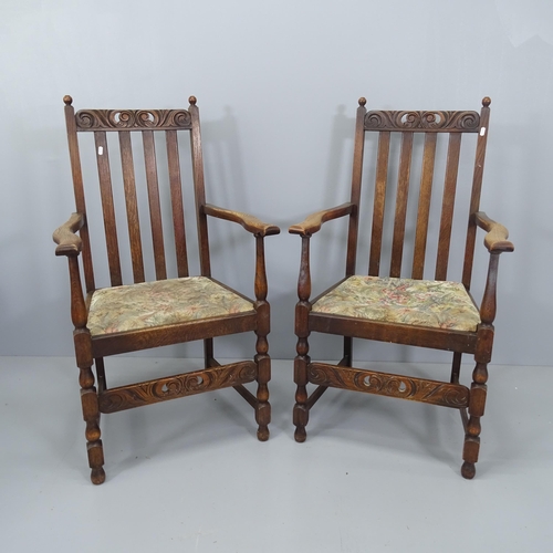 2183 - A pair of antique oak and upholstered open arm chairs, with carved and pierced decoration and drop-i... 