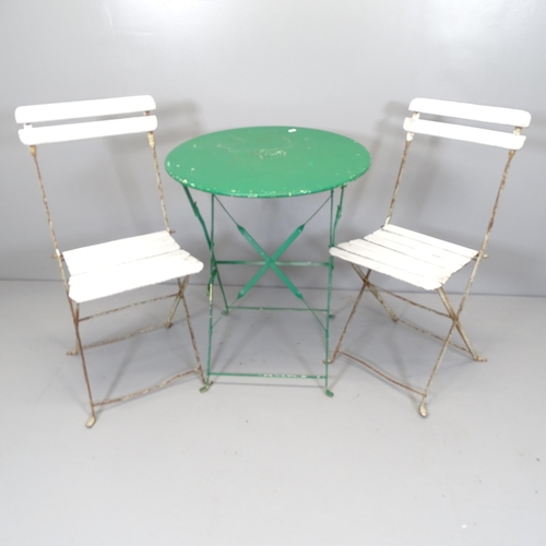 2615 - A French painted metal folding bistro table, and two folding chairs. 60x70cm