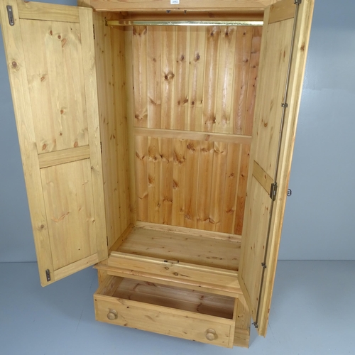 2620 - A modern pine three-section wardrobe, with two panelled doors and drawer under. 102x198x56cm