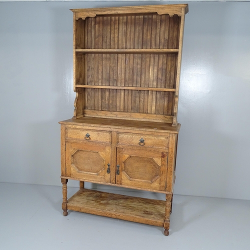 2623 - An early 20th century two-section oak dresser, with two drawers above two panelled cupboard doors an... 