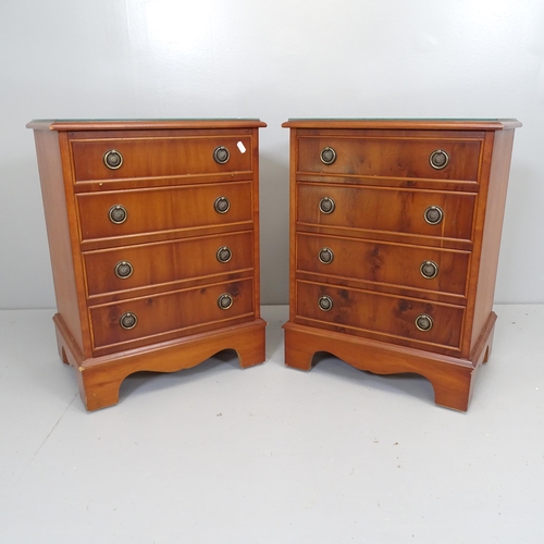 2634 - A pair of reproduction yew-wood bedside chests of four drawers, raised on bracket feet. 45x61x35cm